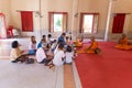 Phuket, Thailand, 04/19/2019 - Single buddhist monk praying with a family at the Chalong Temple