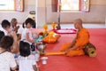 Phuket, Thailand, 04/19/2019 - Single buddhist monk praying with a family at the Chalong Temple