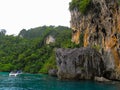 Phuket, Phuket Thailand - 10 15 2012: small boat with tourists stopped near a huge rock so that tourists could understand the