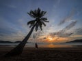 Phuket, Thailand. Tropical beach paradise with beach swing with women sitting. sunset with silhouette women relax on swing under Royalty Free Stock Photo