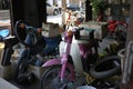 Phuket workshop junk and old motor scooters in pink and blue