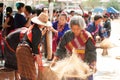 Phutai minority woman Pounding and winnowing rice.