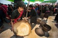 Phutai minority woman pounding and winnowing rice.