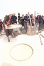 Phutai minority woman pounding and winnowing rice.