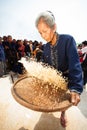 Phutai minority woman winnowing rice.