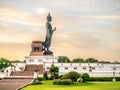 Phutthamonthon Buddha walking statue under evening cloudy sky in Thailand