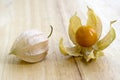 Physalis peruviana orange ripened fruits in husk on wooden table Royalty Free Stock Photo