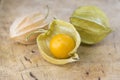 Physalis peruviana orange ripened fruits in husk on wooden table Royalty Free Stock Photo