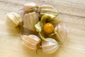 Physalis peruviana ripened fruits in husk on wooden table Royalty Free Stock Photo