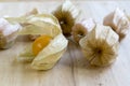 Physalis peruviana orange ripened fruits in husk on wooden table Royalty Free Stock Photo