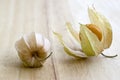 Physalis peruviana orange ripened fruits in husk on wooden table Royalty Free Stock Photo