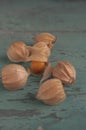 Physalis peruviana ripened orange yellow cape gooseberry goldenberry edible tasty ingredient fruits spread on wooden background Royalty Free Stock Photo