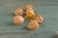 Physalis peruviana ripened orange yellow cape gooseberry goldenberry edible tasty ingredient fruits spread on wooden background Royalty Free Stock Photo