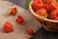 Physalis in a wicker basket on the table Royalty Free Stock Photo