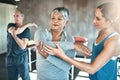 Physical activity helps improve overall muscle health. a senior man and woman working out with the help of an instructor