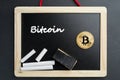 Physical Bitcoin gold coin on a blackboard with chalk Royalty Free Stock Photo