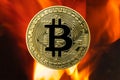 Physical Bitcoin gold coin BTC with fire or flame background Royalty Free Stock Photo