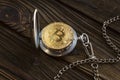 The physical bitcoin and vintage pocket watch shows that time is running out. Royalty Free Stock Photo