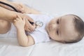 The Physical Checkup. Baby`s Checkup. The pediatrician examining little boy with a stethoscope. Doctor examining the 6-month old Royalty Free Stock Photo