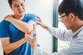 Physical Doctor consulting with patient About elbow muscule pain problems Physical therapy diagnosing concept Royalty Free Stock Photo