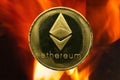 Physical Ethereum gold coin ETH with fire or flame background Royalty Free Stock Photo