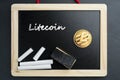 Physical Litecoin gold coin on a blackboard with chalk Royalty Free Stock Photo