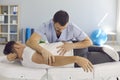 Chiropractor, osteopath, physiotherapist or manual therapist working with male patient
