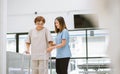 physical therapist helping senior patient in using walker during rehabilitation Royalty Free Stock Photo