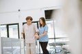 Physical therapist helping senior patient in using walker during rehabilitation Royalty Free Stock Photo