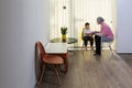 A physical therapist or nurse is talking to and caring for a young child with multiple disabilities in the clinic, rehabilitation