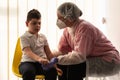 A physical therapist or nurse is talking to and caring for a young child with multiple disabilities in the clinic, rehabilitation