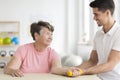 Physical therapist supporting his ward Royalty Free Stock Photo