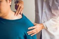 Physical therapists are using their hands to press the clavicle of the patient