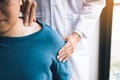 Physical therapists are using their hands to press the clavicle of the patient