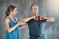 Physical therapy, dumbbell and coaching with old man and personal trainer for support, health and physiotherapy Royalty Free Stock Photo