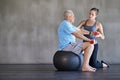 Physical therapy, dumbbells and elderly man on ball for fitness, rehabilitation or exercise at gym on mockup. Senior Royalty Free Stock Photo