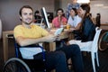 Physically disabled man on wheelchair using tablet in office Royalty Free Stock Photo