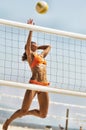 Portrait of Physically Fit Young Woman Spiking Volleyball Royalty Free Stock Photo