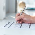 Physician doctor writing on medical health care record, patients discharge, or prescription form paperwork in hospital clinic Royalty Free Stock Photo