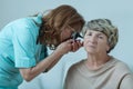 Physician examining elderly woman