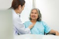 Physician examining heart with a stethoscope and talking with a senior woman at a clinic for check yearly checkup, Medicine health