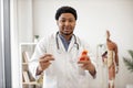 Physician holding medicine containers in consulting room Royalty Free Stock Photo