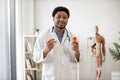 Physician holding medicine containers in consulting room Royalty Free Stock Photo