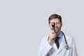 Physician looking through ophthalmoscope