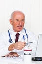 Physician in practice with stethoscope and laptop. Royalty Free Stock Photo