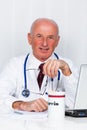 Physician in practice with stethoscope and laptop. Royalty Free Stock Photo