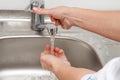 Physician is washing his hands under tap water Royalty Free Stock Photo