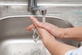 Physician is washing his hands under tap water Royalty Free Stock Photo