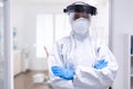 Physician wearing face shield and hazmat suit agasint contamination with coroanvirus Royalty Free Stock Photo