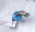 Doctor holds a pack of paper money, anti-corruption concept, bribe Royalty Free Stock Photo